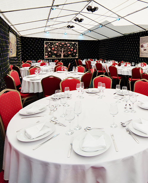 An event space with fairy lights and tables