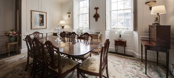 A panelled room with a dining table