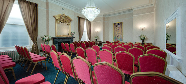 An elegant room set up with chairs for a conference